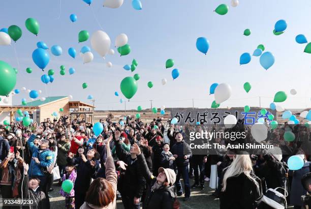 People release balloons in commemoration for the victims on the 7th anniversary of the Great East Japan Earthquake on March 11, 2018 in Ishinomaki,...