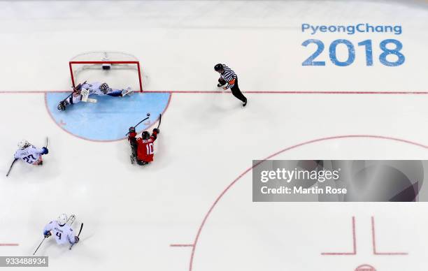 Ben Delaney of Canada fails to score over Steve Cash, goaltender of United States in the Ice Hockey gold medal game between Canada and United States...