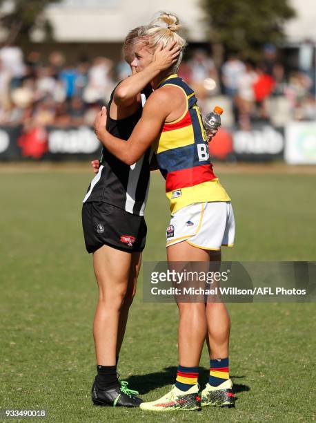 Emma Grant of the Magpies and Erin Phillips of the Crows embrace during the 2018 AFLW Round 07 match between the Collingwood Magpies and the Adelaide...