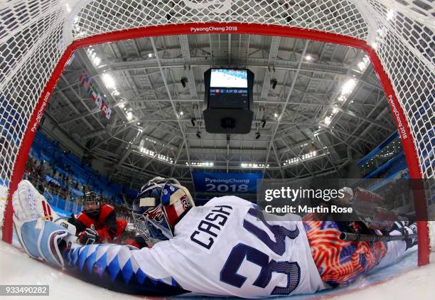 Ben Delaney of Canada fails to score over Steve Cash, goaltender of United States in the Ice Hockey gold medal game between Canada and United States...