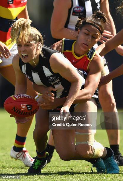 Kristy Stratton of the Magpies handballs whilst being tackled during the round seven AFLW match between the Collingwood Magpies and the Adelaide...