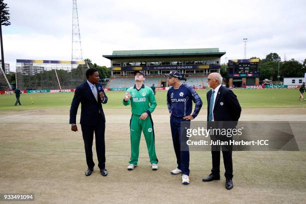 Pommie Mbangwa and Match Referee Dev Govindjee oversee the Coin toss by William Porterfield of Ireland and Matthew Cross of Scotland during The ICC...