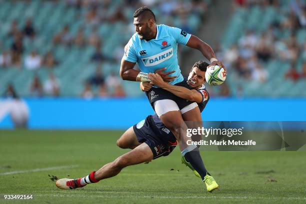 Taqele Naiyaravoro of the Waratahs is tackled by Jack Debreczeni of the Rebels during the round five Super Rugby match between the Waratahs and the...