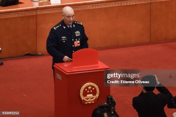 Vice chairman of the Central Military Commission of the People's Republic of China Xu Qiliang votes during the sixth plenary session of the National...