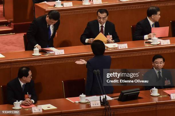 President of the All China Women's Federation Shen Yueyue asks Chinese President Xi Jinping and Chinese Premier Li Keqiang to cast their ballots...