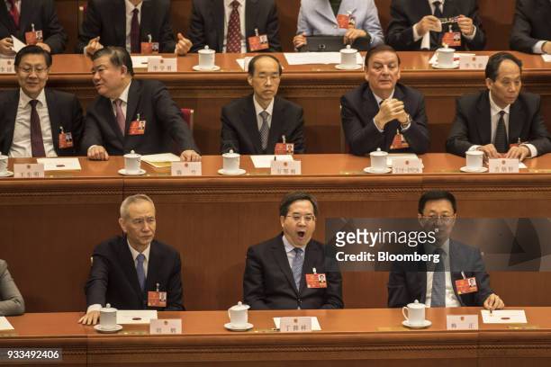 Delegates attend a session at the first session of the 13th National People's Congress at the Great Hall of the People in Beijing, China, on Sunday,...