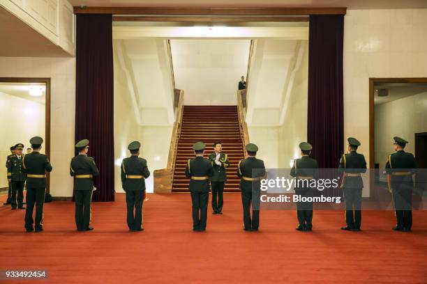 Members of the People's Liberation Army band stand ahead of a session at the first session of the 13th National People's Congress at the Great Hall...