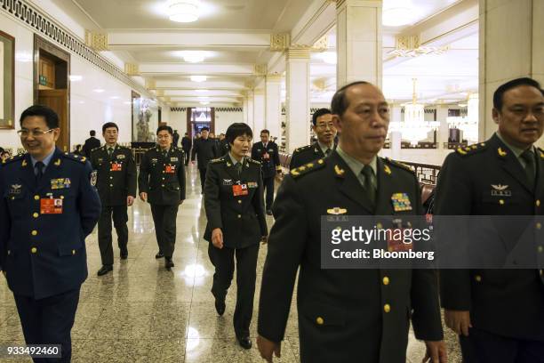 Military delegates arrive for a session at the first session of the 13th National People's Congress at the Great Hall of the People in Beijing,...