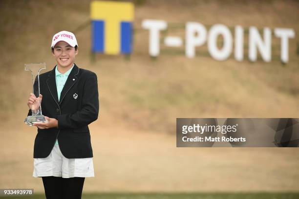 Suzuka Yamaguchi of Japan poses with her trophy during the final round of the T-Point Ladies Golf Tournament at the Ibaraki Kokusai Golf Club on...