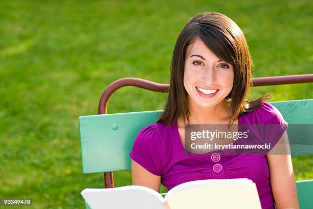 woman reading book - teenybopper stockfoto's en -beelden