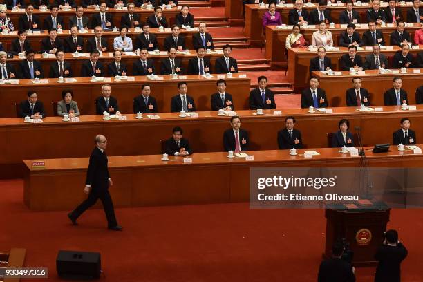 Newly appointed Procurator-General of China's Supreme People's Procuratorate Zhang Jun walks to a podium to swear an oath during the sixth plenary...