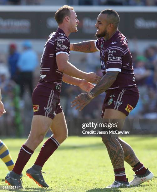 Daly Cherry-Evans celebrates with Addin Fonua-Blake of the Sea Eagles after scoring a try during the round two NRL match between the Manly Sea Eagles...