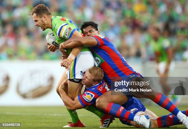 Aiden Seizer of the Raiders is tackled during the round two NRL match between the Canberra Raiders and the Newcastle Knights at GIO Stadium on March...