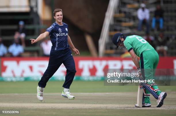 Brad Wheal of Scotland celebrates the wicket of William Porterfield of Ireland during The ICC Cricket World Cup Qualifier at The Old Hararians Ground...