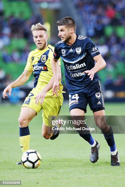 Terry Antonis of the Victory controls the ball from Andrew Hoole of the Mariners during the round 23 A-League match between the Melbourne Victory and...