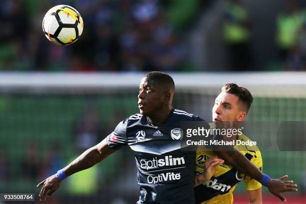 Leroy George of the Victory and Storm Roux of the Mariners compete for the ball during the round 23 A-League match between the Melbourne Victory and...