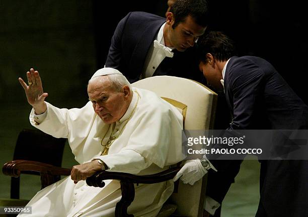 Pope John Paul II waves to pilgrims gathered at the Vatican for the weekly's general audience 27 August 2003. A frail Pope returned to hold his first...