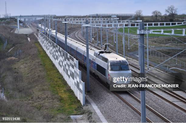 High-speed LGV train that links Paris to Rennes rides past an anti-noise barrier, near the Sable-Sur-Sarthe junction, on March 17, 2018 in...