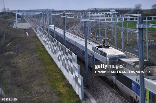 High-speed LGV train that links Paris to Rennes rides past an anti-noise barrier, near the Sable-Sur-Sarthe junction, on March 17, 2018 in...
