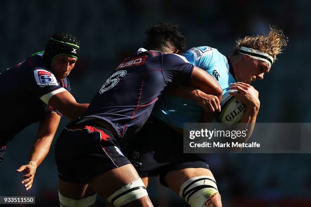 Ned Hanigan of the Waratahs is tackled during the round five Super Rugby match between the Waratahs and the Rebels at Allianz Stadium on March 18,...