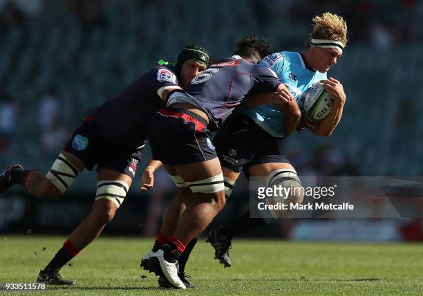 Ned Hanigan of the Waratahs is tackled during the round five Super Rugby match between the Waratahs and the Rebels at Allianz Stadium on March 18,...