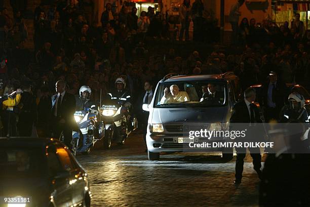 Pope John Paul II leaves Rome's Gemelli hospital aboard a grey minibus with tinted glass windows 13 March 2005 to return to the Vatican, ending an...