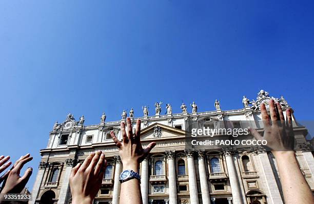 Faithfuls raise their hands in the air in St. Peter's Square at the Vatican City 04 April 2005. Keen to pay their last respect to Pope John Paul II,...
