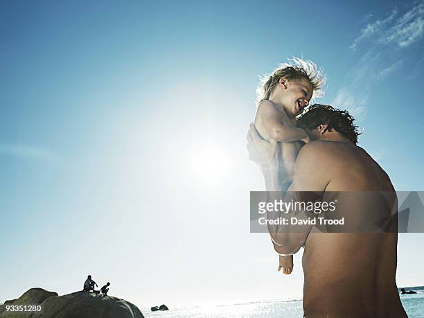 father and son in the sun. - david trood photos et images de collection