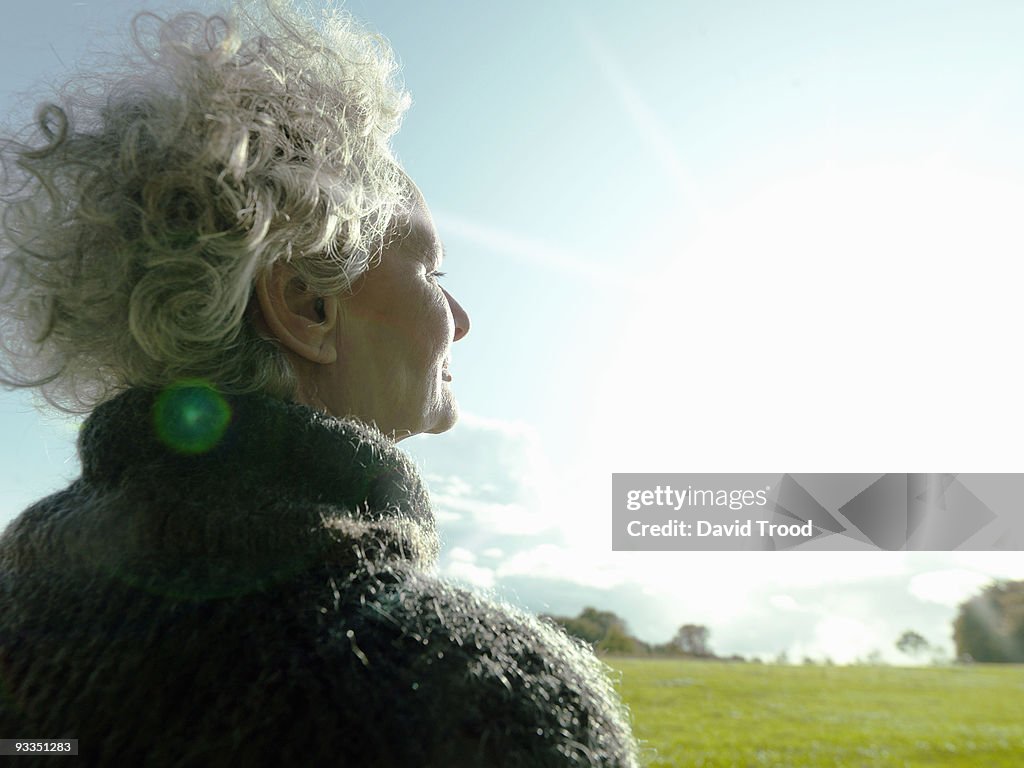 Mature woman looking at the sunrise.