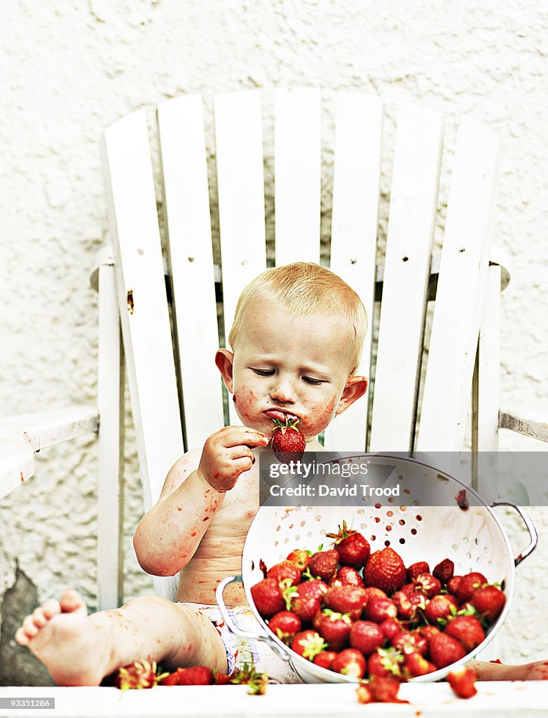 Baby eating strawberries