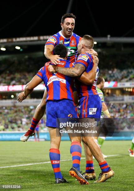 Sione Mata'utia of the Knights celebrates scoring a try with team mates during the round two NRL match between the Canberra Raiders and the Newcastle...