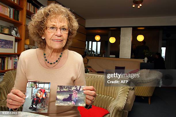 Josephine Nicolaas-Houben, the mother of Rom Houben, holds up pictures of her son in her home in Liege, on November 24, 2009. Rom Houben, a Belgian...