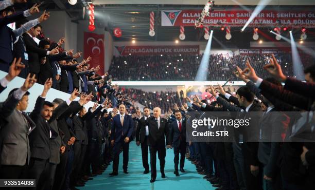 Turkey's right-wing Nationalist Movement Party's Leader, Devlet Bahceli greets the crowd during the party's 12th Ordinary Grand Congress in Ankara on...