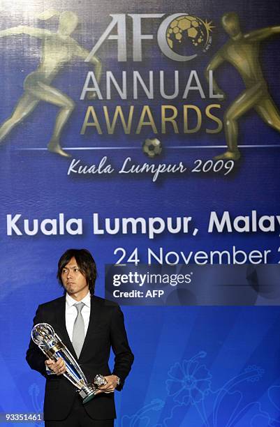 Japanese footballer Yasuhito Endo holds the Asian Football Confederation 2009 Men's Player of the Year award trophy during the AFC Annual Awards...