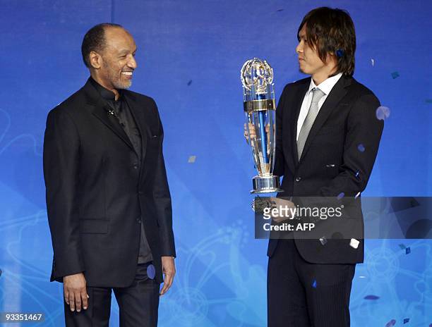 Japanese footballer Yasuhito Endo looks on after receiving the Asian Football Confederation 2009 Men's Player of the Year award from AFC President...