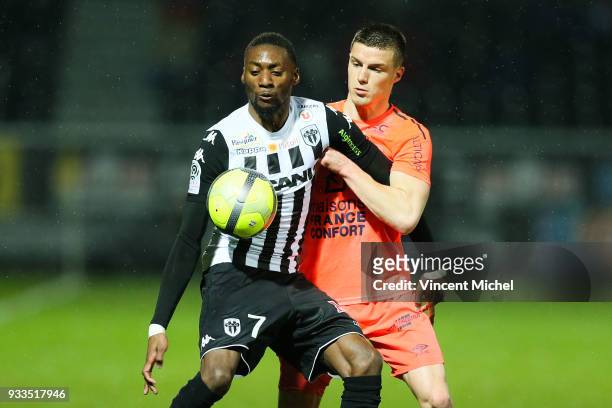 Karl Toko Ekambi of Angers and Frederic Guilbert of Caen during the Ligue 1 match between Angers SCO and SM Caen at Stade Raymond Kopa on March 17,...