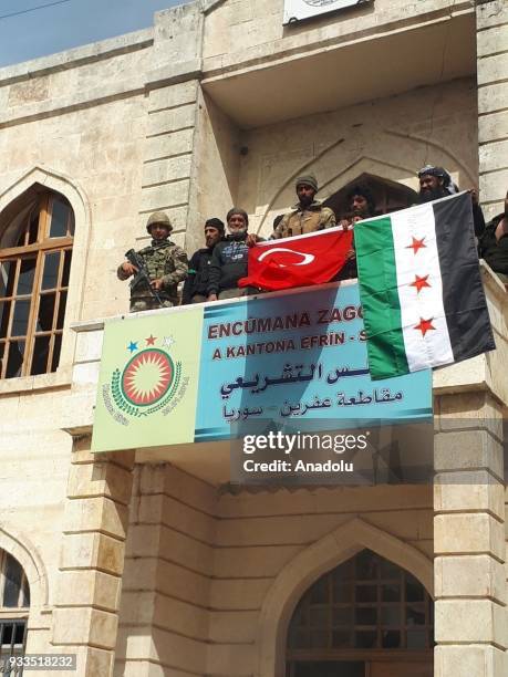 Turkish soldier and Free Syrian Army members display Turkish and Syrian Flags in Afrin town center after Turkish Armed Forces and Free Syrian Army...