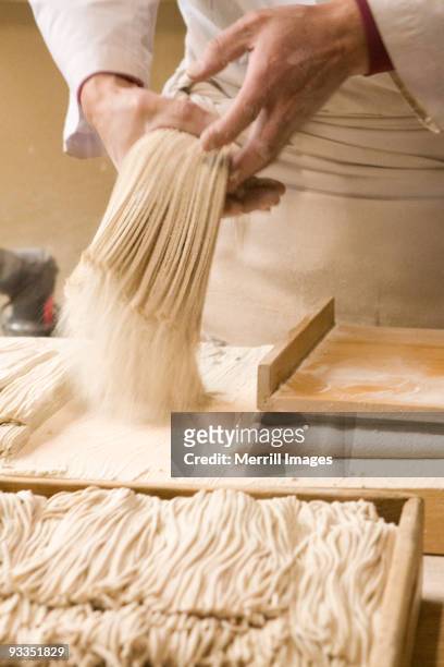 man slicing dough to make soba noodles - soba stock pictures, royalty-free photos & images