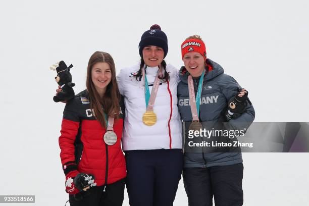 Silver medalist Mollie Jepsen of Canada, gold medalist Marie Bouchet of France, and bronze medalist Andrea Rothfuss of Germany celebrate during the...