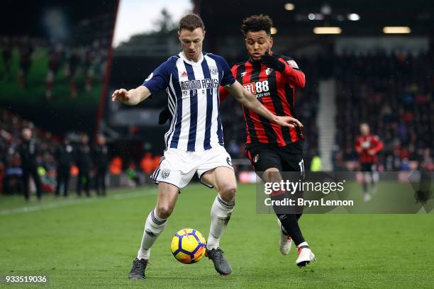 Jonny Evans of West Bromwich Albion is challenged by Joshua King of AFC Bournemouth during the Premier League match between during the Premier League...