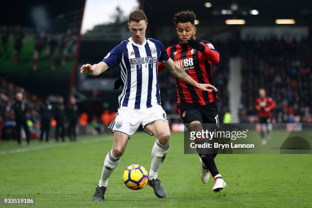 Jonny Evans of West Bromwich Albion is challenged by Joshua King of AFC Bournemouth during the Premier League match between during the Premier League...