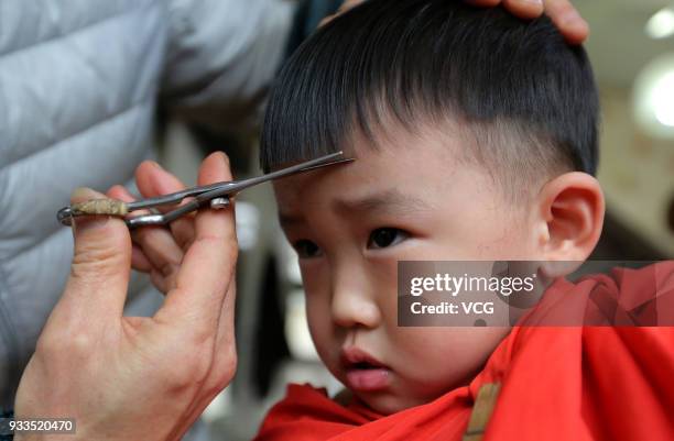 Boy gets a haircut on the Longtaitou Festival on March 18, 2018 in Lianyungang, Jiangsu Province of China. As a traditional custom, Chinese people...