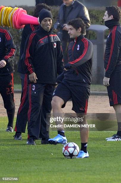 Milan's Brasilian forward Ronaldinho and Brazilian forward Pato take part in a training session on the eve of their team's UEFA Champions League...