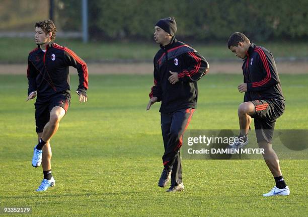 Milan's Brazilian players forward Pato, forward Ronaldinho and defender Thiago Silva take part in a training session on the eve of their team's UEFA...