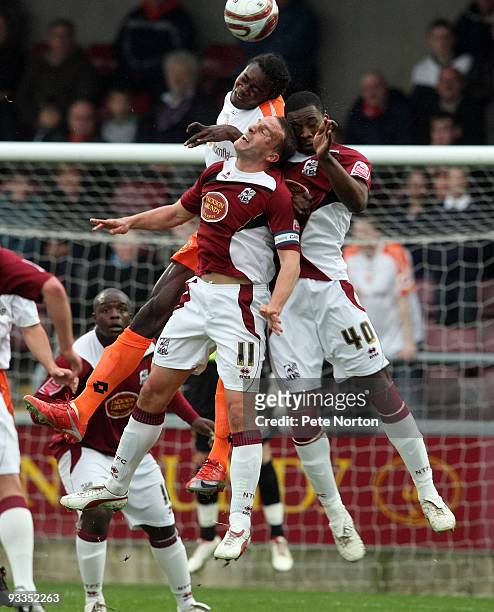 Calvin Zola of Crewe Alexandra challenges for the ball with Andy Holt and Patrick Kanyuka of Northampton Town during the Coca Cola League Two Match...