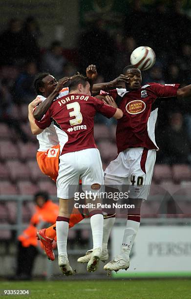 Calvin Zola of Crewe Alexandra challenges for the ball with Patrick Kanyuka and John Johnson of Northampton Town during the Coca Cola League Two...