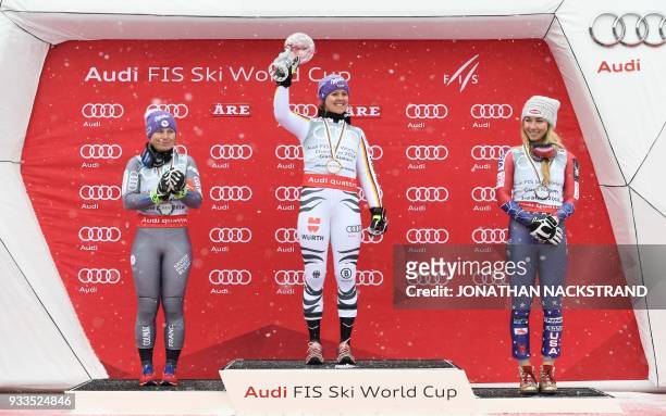 Overall winners of the Women's Giant Slalom discipline of the Alpine Skiing World Cup celebrate on the podium Tessa Worley of France, Viktoria...