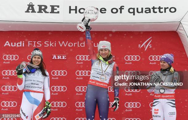 Overall winners of the Women's Alpine Skiing World Cup celebrate on the podium Wendy Holdener of Switzerland, Mikaela Shiffrin of the US and Viktoria...