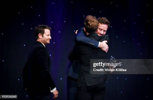 Armie Hammer presents Nate Berkus and Jeremiah Brent an award on stage at Family Equality Council's Impact Awards at The Globe Theatre at Universal...