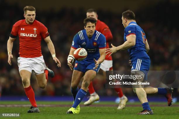 Francois Trinh-Duc of France feeds a pass to Camille Chat as Dan Biggar of Wales closes in during the NatWest Six Nations match between Wales and...